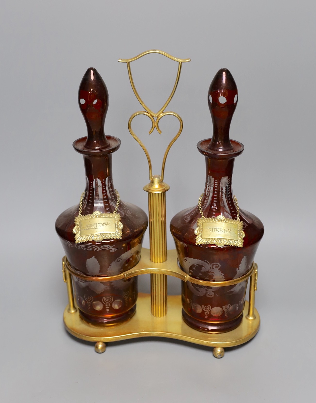 A pair of Bohemian cut glass decanters on gilt metal stand with ‘WHISKY’ and ‘SHERRY’ labels, 38cm total